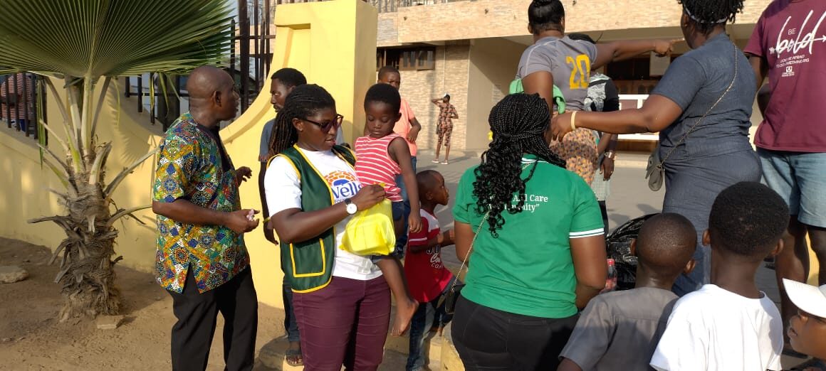 Wells Foundation volunteers distributing gifts to children in Ghana
