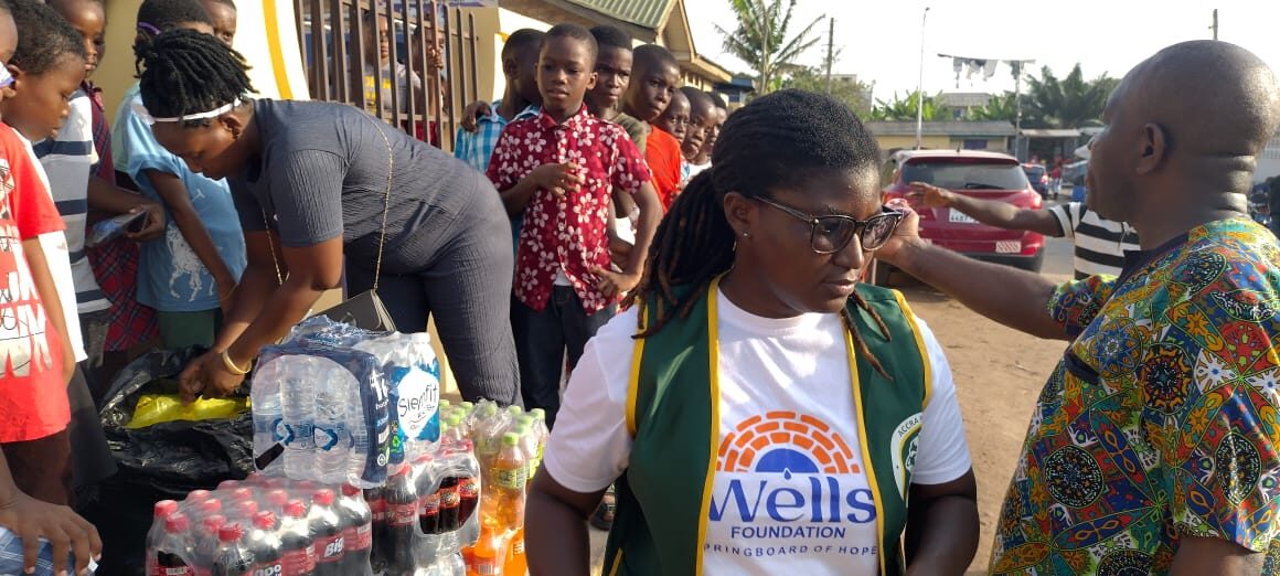 Volunteers handing out water and refreshments at a Wells Foundation event