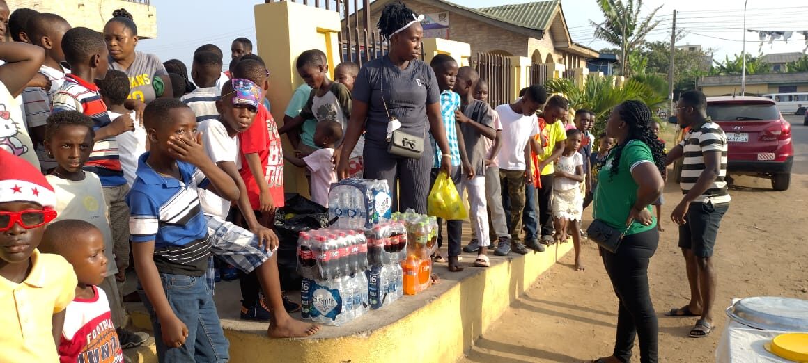 Families lining up for donations at a Wells Foundation community event