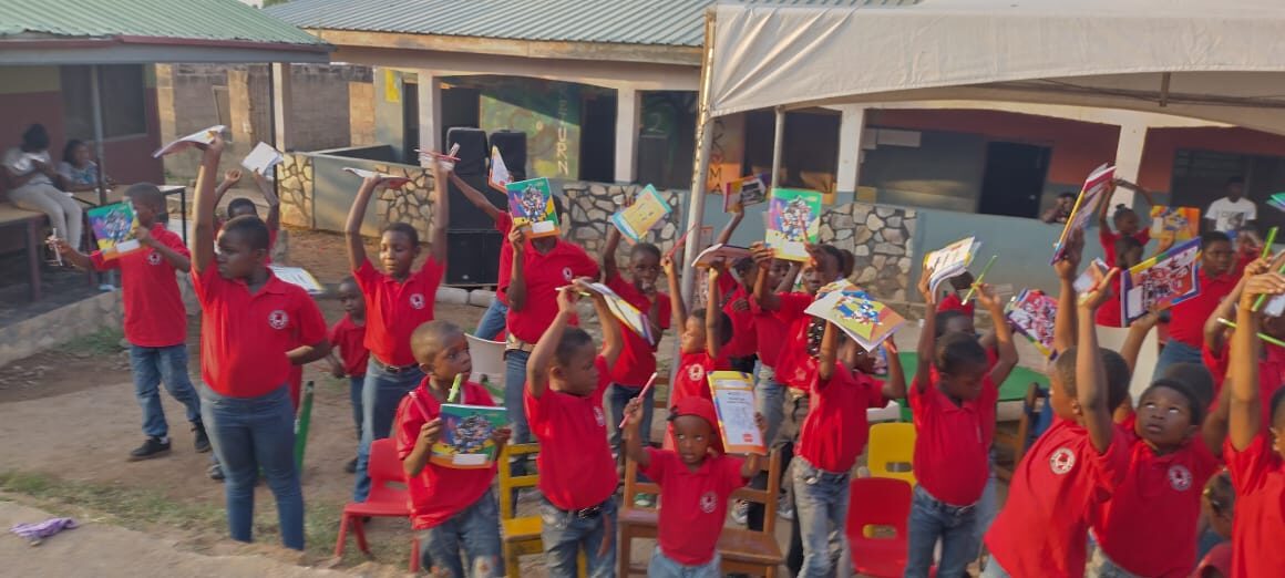Children celebrating with gifts at the Wells Foundation Christmas party in Ghana