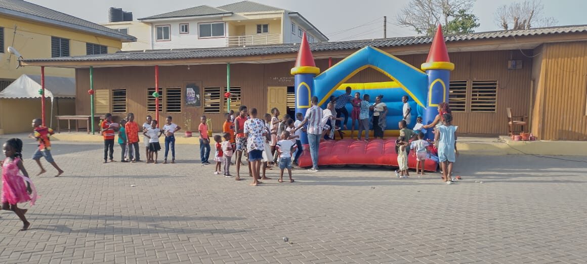 Children playing on the bounce house at a Wells Foundation celebration