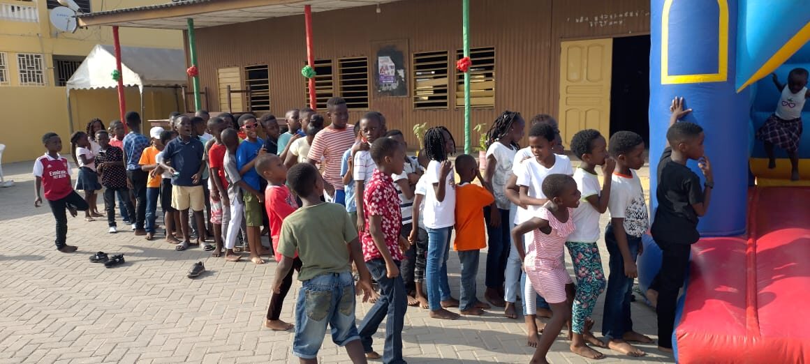Children lining up for activities at a Wells Foundation community celebration
